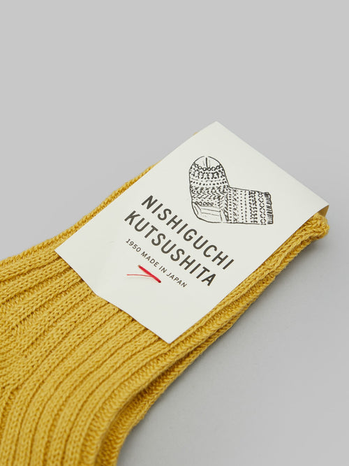 nishiguchi kutsushita linen ribbed socks canary yellow front  label